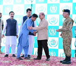 Prime Minister Muhammad Shehbaz Sharif distributing relief cheques among the victims of the recent torrential rains and floods in Buner