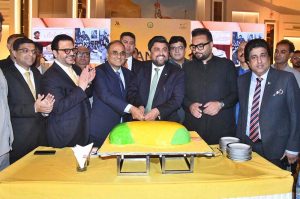 Sindh Governor Kamran Khan Tessori, along with other dignitaries, cuts a mango cake during a festival hosted by the Ministry of Foreign Affairs at a local hotel