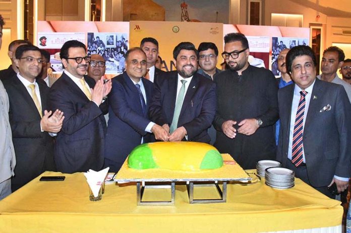 Sindh Governor Kamran Khan Tessori, along with other dignitaries, cuts a mango cake during a festival hosted by the Ministry of Foreign Affairs at a local hotel