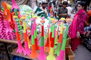 Workers tie and pack bundles of printed Pakistani flag buntings to be used in preparations for the upcoming Independence Day celebrations across the country