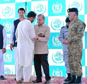 Prime Minister Muhammad Shehbaz Sharif distributing relief cheques among the victims of the recent torrential rains and floods in Buner