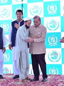 Prime Minister Muhammad Shehbaz Sharif distributing relief cheques among the victims of the recent torrential rains and floods in Buner