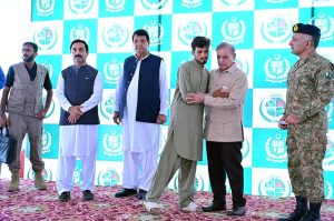 Prime Minister Muhammad Shehbaz Sharif distributing relief cheques among the victims of the recent torrential rains and floods in Buner