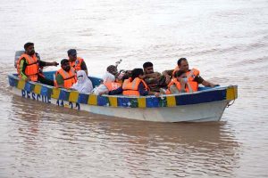 Rescue 1122 team evacuates flood-affected people to safer places by boat during a relief operation