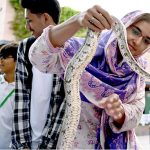 A women holding a Snake during Pets Show on the occasion of the Pakistan Independence Day & Marka-E-Haq Grand Celebrations at Arts Council of Pakistan