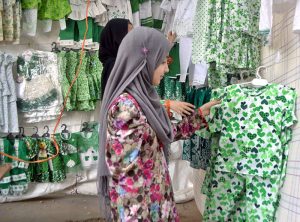 Children selecting national flags and badges from a stall in connection with celebration of 78th Independence Day with the theme of Maarka-E-Haq at Latifabad