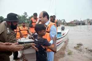 Chairman Prime Minister’s Youth Programme, Rana Mashhood Ahmad Khan, is seen with the rescue team helping people in the flood-hit area of Talat Park Bhadro Pind.