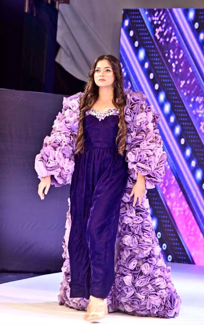 A model walks the ramp in a stylish outfit during the first inter-university fashion show competition at Government College Women’s University Faisalabad (GCWUF)
