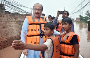 Chairman Prime Minister’s Youth Programme, Rana Mashhood Ahmad Khan, is seen with the rescue team helping people in the flood-hit area of Talat Park Bhadro Pind.