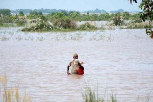 Rescue 1122 team evacuates flood-affected people to safer places by boat during a relief operation