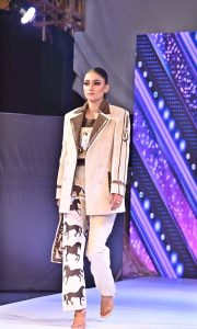 A model walks the ramp in a stylish outfit during the first inter-university fashion show competition at Government College Women’s University Faisalabad (GCWUF)