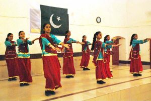 Schoolgirls perform on national songs at a function held at Government SD High School Bahawalpur to mark the Marka-e-Haq and Independence Day celebrations