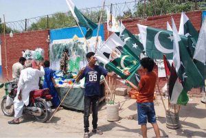 Children select National flags from roadside stalls, brimming with excitement to celebrate Independence Day with full patriotic spirit