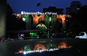 An illuminated view of the Associated Press of Pakistan Headquarters building, decorated with colourful lights in connection with Independence Day celebrations.