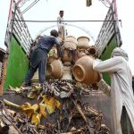 Laborers load plant pots onto a delivery truck for sale in the Musazai area