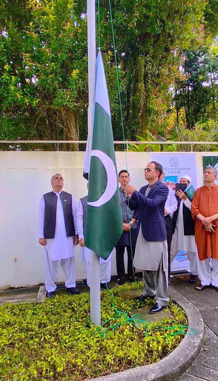 Charge d'Affaires, Salman Mahmood hoisting the national flag in a Flag Hoisting Ceremony in Pakistan House