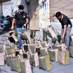 Vendors display traditional handmade bags at a roadside to attract customers
