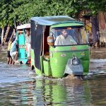 Vehicles passing through accumulated water at Makkah Road after rain in the Provincial Capital