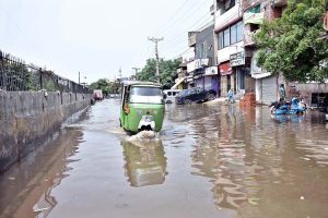 Vehicles passing through accumulated water at Makkah Road after rain in the Provincial Capital