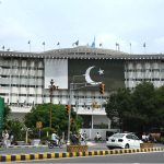 The WAPDA House building decorated with lights and Pakistan's national flag to commemorate the country's 78th Independence Day, 'Maarka e Haq'