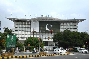 The WAPDA House building decorated with lights and Pakistan's national flag to commemorate the country's 78th Independence Day, 'Maarka e Haq'