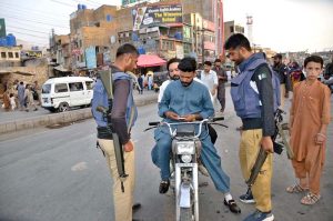 Police personnel checking motorcyclists’ IDs and licences at Meezan Chowk as the provincial government enforces Section 144 on motorcycle riding ahead of Independence Day