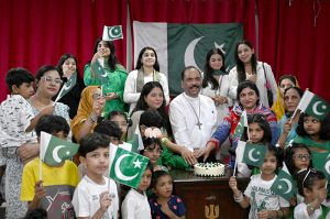 Dr. Majid Abel, Senior Pastor, cutting cake the Independence Day at the Presbyterian Church of Pakistan (Nawlakha)