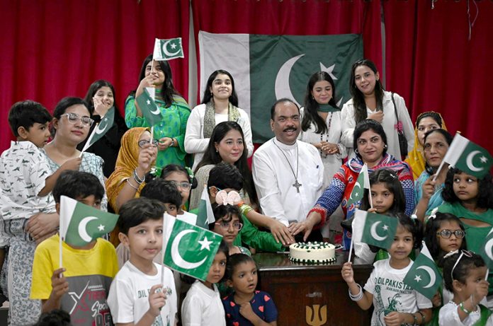 Dr. Majid Abel, Senior Pastor, cutting cake the Independence Day at the Presbyterian Church of Pakistan (Nawlakha)