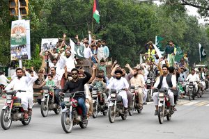 Children celebrating Independence Day of Pakistan riding an auto rickshaw on Mall Road