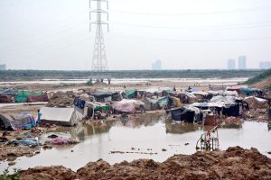 Shanties of gypsies near the road to Korangi submerged in water due to heavy downpour experienced in the city
