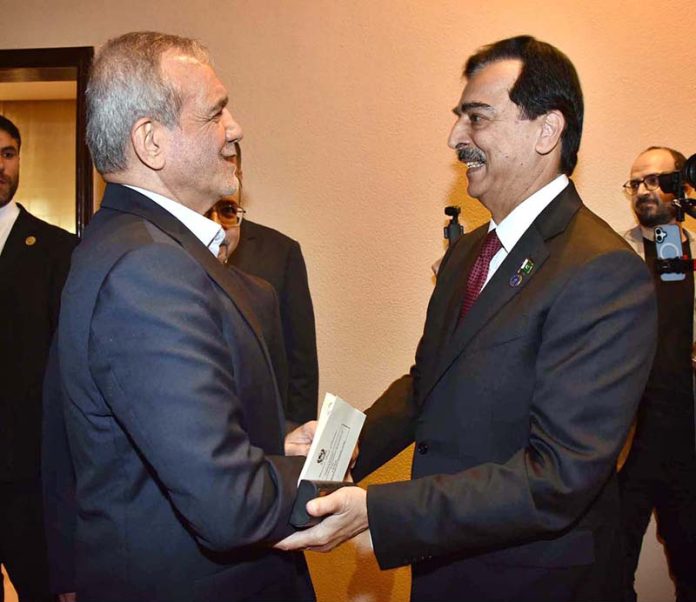 Chairman Senate, Syed Yousuf Raza Gillani shaking hand with H.E. Dr. Masoud Pezeshkian, President of the Islamic Republic of Iran