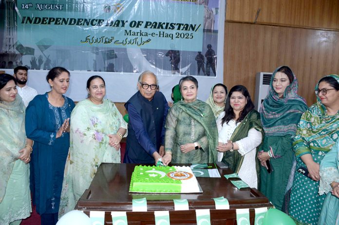 Vice Chancellor GCWUF Prof Dr Kanwal Ameen is cutting a cake during a flag hoisting ceremony organized in Government College Women University Faisalabad (GCWUF) to celebrate Independence Day and Marka-e-Haq