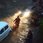 Torrential monsoon rain drenches the city, turning streets into streams and bringing a pause to the daily life