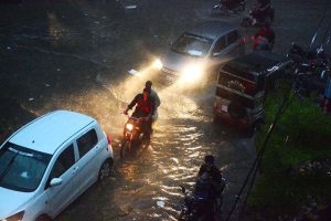 Torrential monsoon rain drenches the city, turning streets into streams and bringing a pause to the daily life