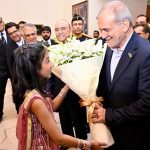 A child greets the visiting Iranian President, Dr Masoud Pezeshkian, with a bouquet in Awan-e- Sadr