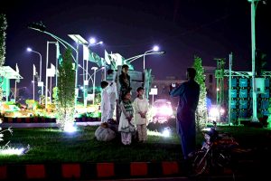 A man captures picture of his children with the well decorated buildings of Aiwan e Sadr and Parliament House in national celebration with the theme of “Maarka-e-Haq” (Struggle for Right) profoundly resonant for Pakistan’s Independence Day