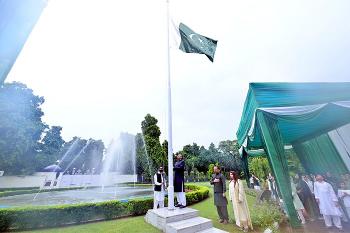 Mr. Saad Ahmad Warraich hoisting a national flag at the flag hoisting ceremony at the Pakistan High Commission