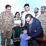 Managing Director Pakistan Bait-ul-Mal Senator Capt. Shaheen Khalid Butt talking to a child after his PBM-funded Cochlear Implant Surgery at CMH
