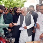 Federal Minister for Board of Investment, Qaiser Ahmad Sheikh distributing 5 litre free petrol slips to the motor cyclists to celebrate the Jashn e Azadi