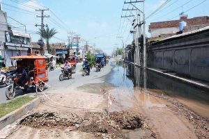 Stagnant sewage water after overflow create a deep hole on Millat Road, choking traffic flow and spotlighting glaring civic negligence