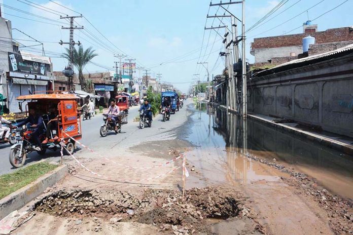 Stagnant sewage water after overflow create a deep hole on Millat Road, choking traffic flow and spotlighting glaring civic negligence