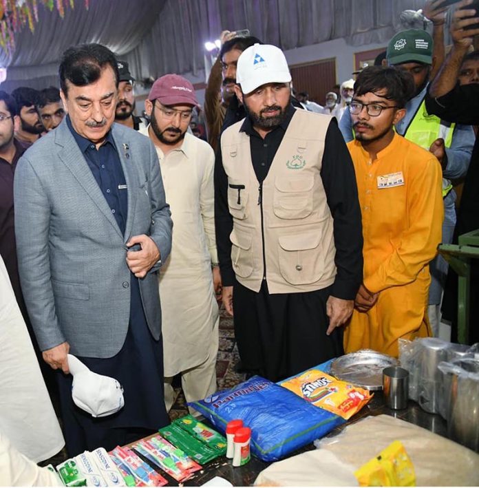 Acting President Syed Yousuf Raza Gilani inspecting relief items as Chief Guest at the distribution ceremony of essential relief packages to 300 flood-affected households, organized by the Farmers Development Organization (FDO) in collaboration with the Pakistan Poverty Alleviation Fund (PPAF) at Union Council Sher Shah