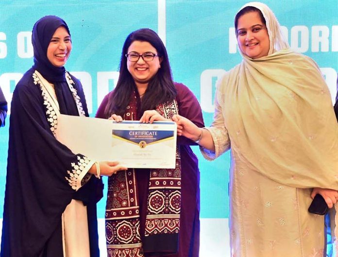 Federal Minister for IT & Telecom, Ms. Shaza Fatima Khawaja, distributing certificates to a graduate during the convocation of Cohort 4 and 5 at the National Incubation Centre, encouraging youth-led entrepreneurship