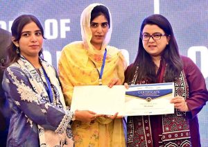 Federal Minister for IT & Telecom, Ms. Shaza Fatima Khawaja, distributing certificates to a graduate during the convocation of Cohort 4 and 5 at the National Incubation Centre, encouraging youth-led entrepreneurship