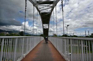 A worker is busy painting a pedestrian bridge at Zero Point in the Federal Capital