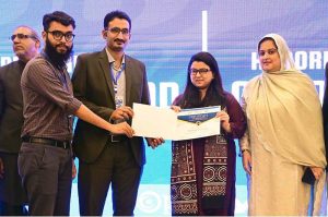 Federal Minister for IT & Telecom, Ms. Shaza Fatima Khawaja, distributing certificates to a graduate during the convocation of Cohort 4 and 5 at the National Incubation Centre, encouraging youth-led entrepreneurship