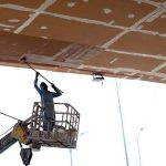 Worker is busy paint the bridge at Peshawar Mor Interchange in the Federal Capital