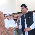 Federal Minister for Kashmir Affairs, Gilgit Baltistan and SAFRON Engr Amir Muqam and Special Assistant to Prime Minister Talha Burki distributing relief cheques among the victims of the recent torrential rains and floods