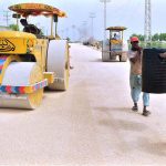 Labourers busy in construction work of New Airport Road during development work in the city