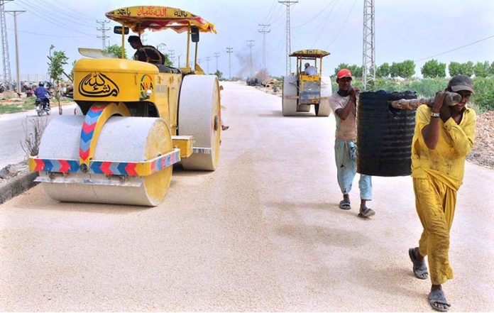 Labourers busy in construction work of New Airport Road during development work in the city